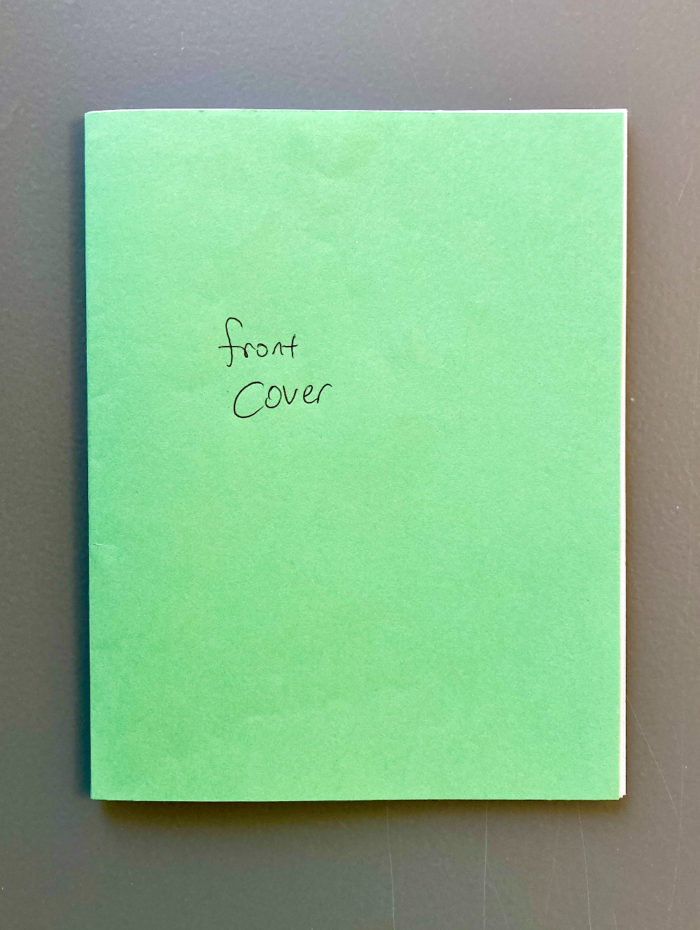 A folded mock-up for a zine. The outside pages are green. The front says "front cover."