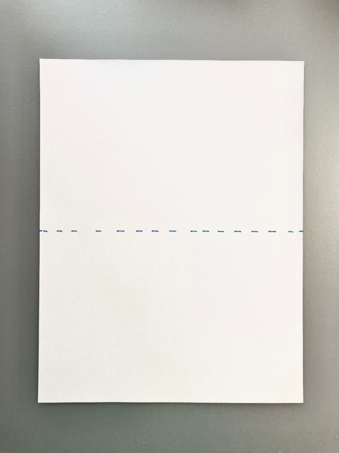 A blank sheet of white paper with a horizontal dotted line across the middle.