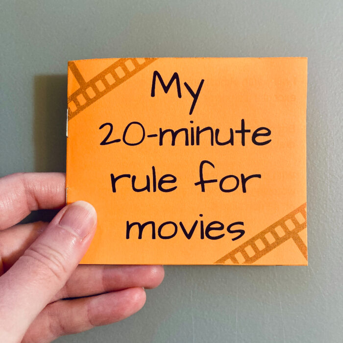A hand holding "My 20-minute rules for movies" zine
