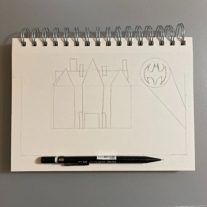 A pencil sketch of Bruce Wayne's mansion. To the right of the building, there's a bat symbol in the sky.