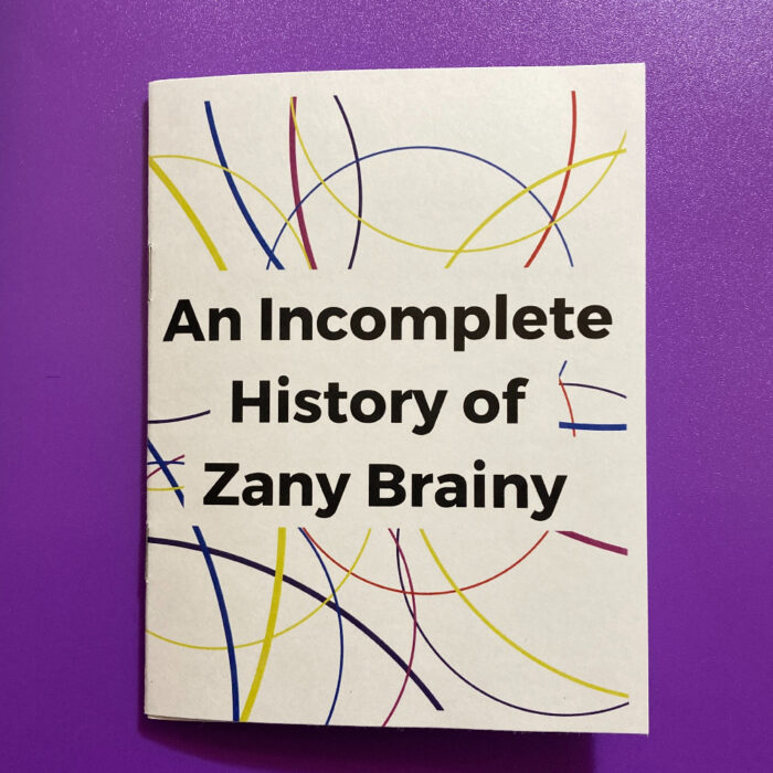 The cover of "An Incomplete History of Zany Brainy" zine on a purple background.