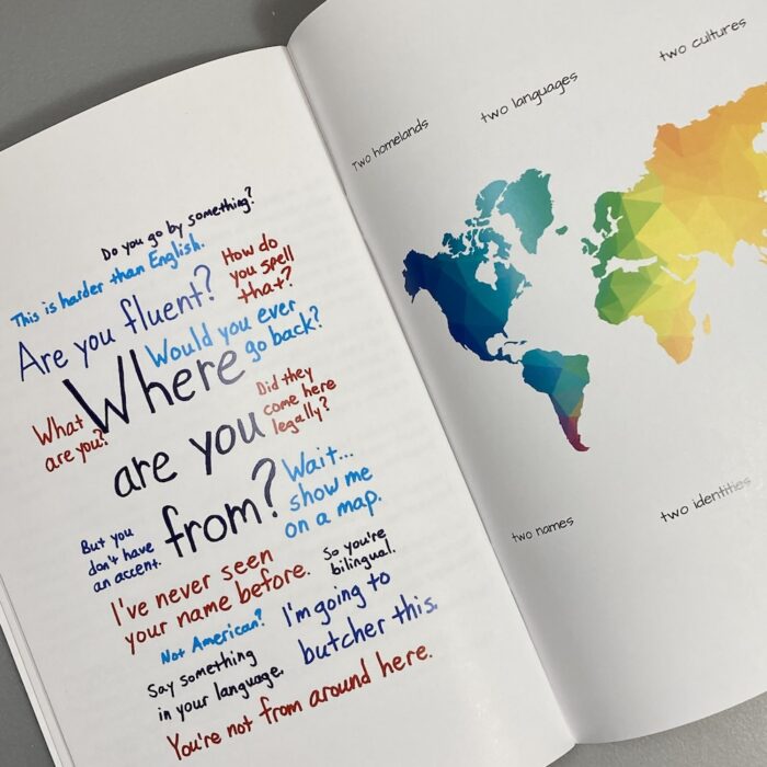 Two pages of the "Children of Immigrants" zine. The left page has a series of phrases and questions on the theme "Where are you from?" Sentences are examples of questions and comments that immigrants hear about their background and language. The right page has a colorful world map. Black text says "Two homelands, two languages, two cultures. Two names, two identities."